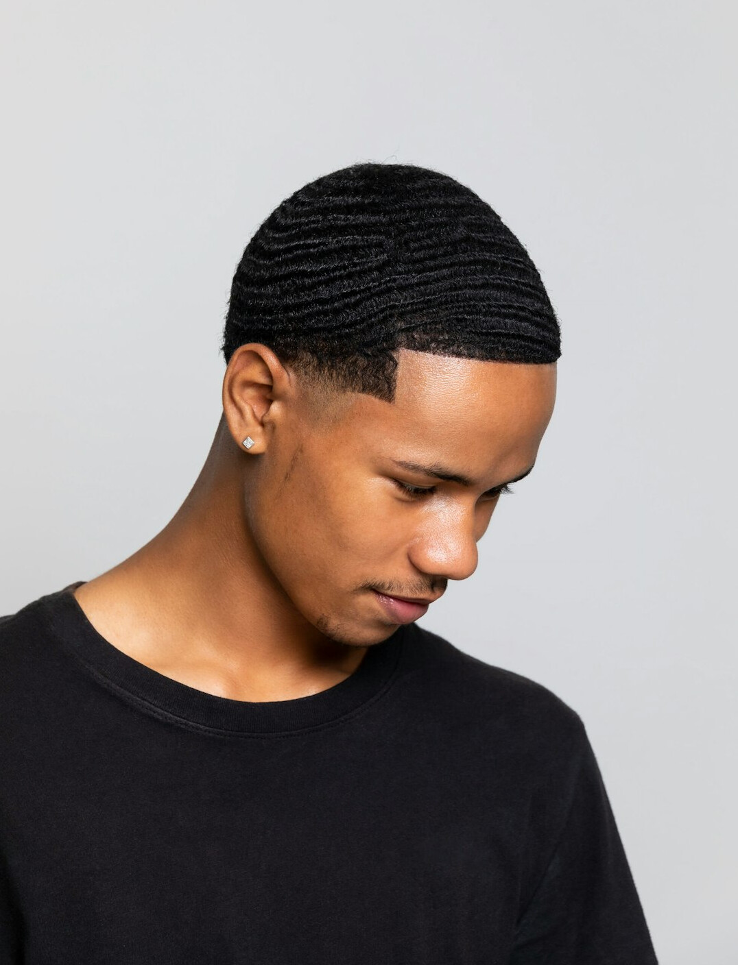 Studio headshot of a Black man with short hair