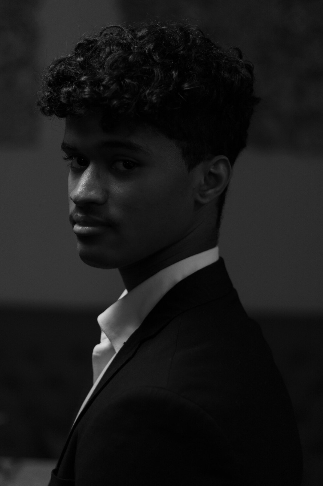 Studio headshot of a North African man in a suit